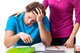 Woman comforting a depressed man who is sitting at a desk looking at paperwork [Image by creator Photographee.eu from AdobeStock]